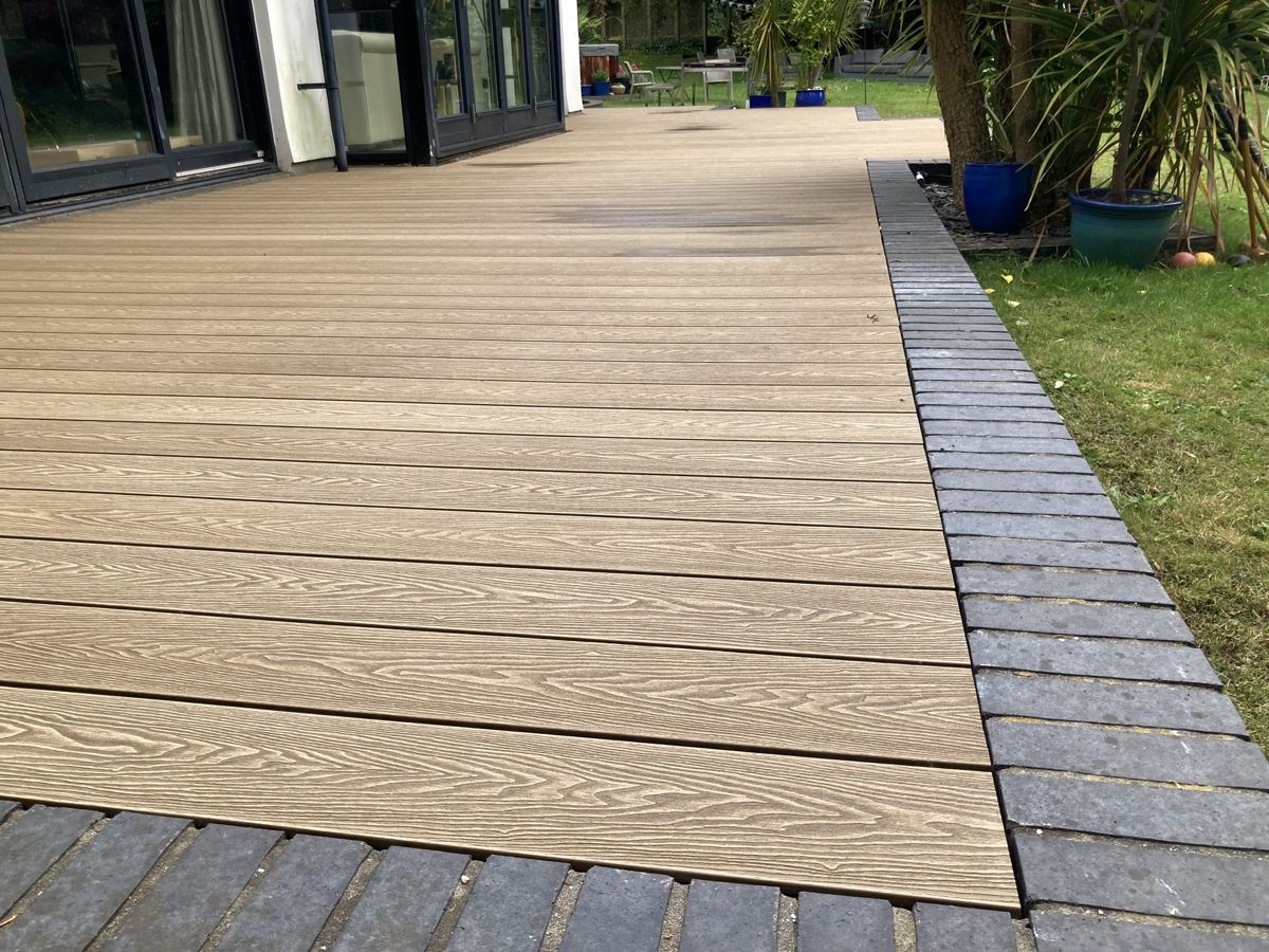 Long composite deck run with brick edging